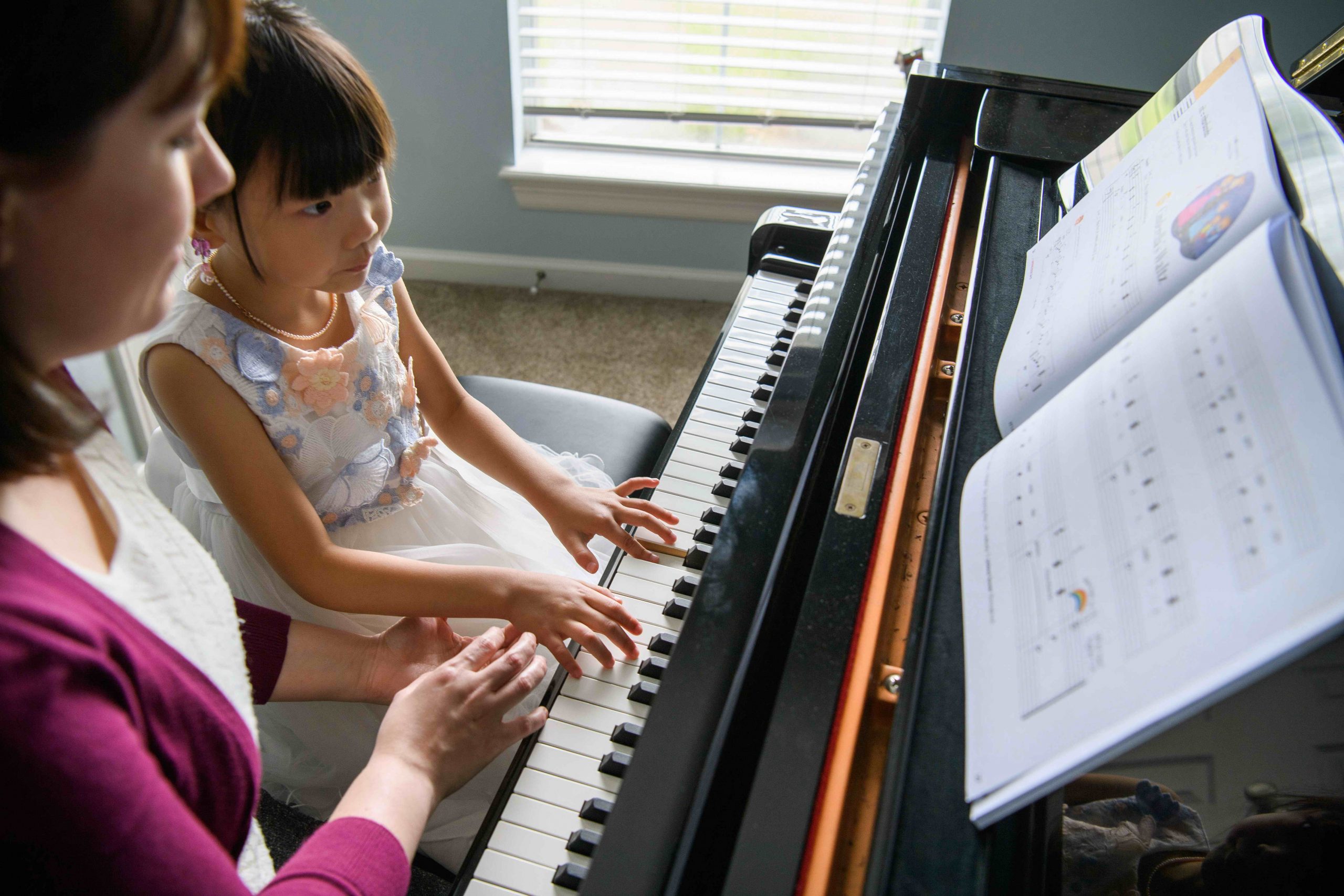 Young child piano lesson with teacher